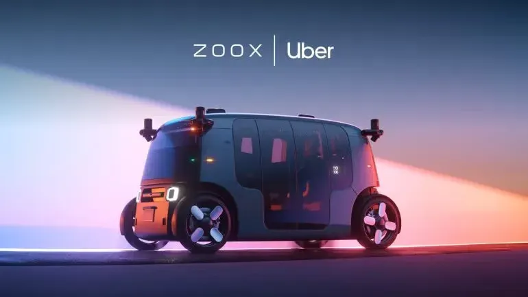 A Zoox robotaxi under the Zoox and Uber logos