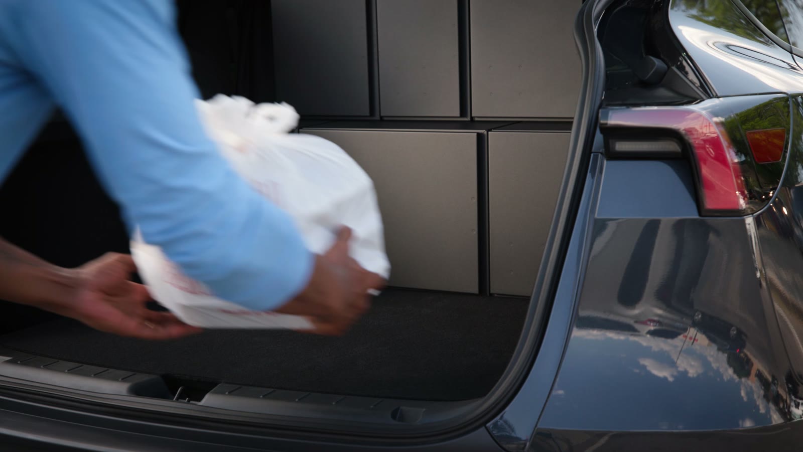 Staff loading an order into a compartment